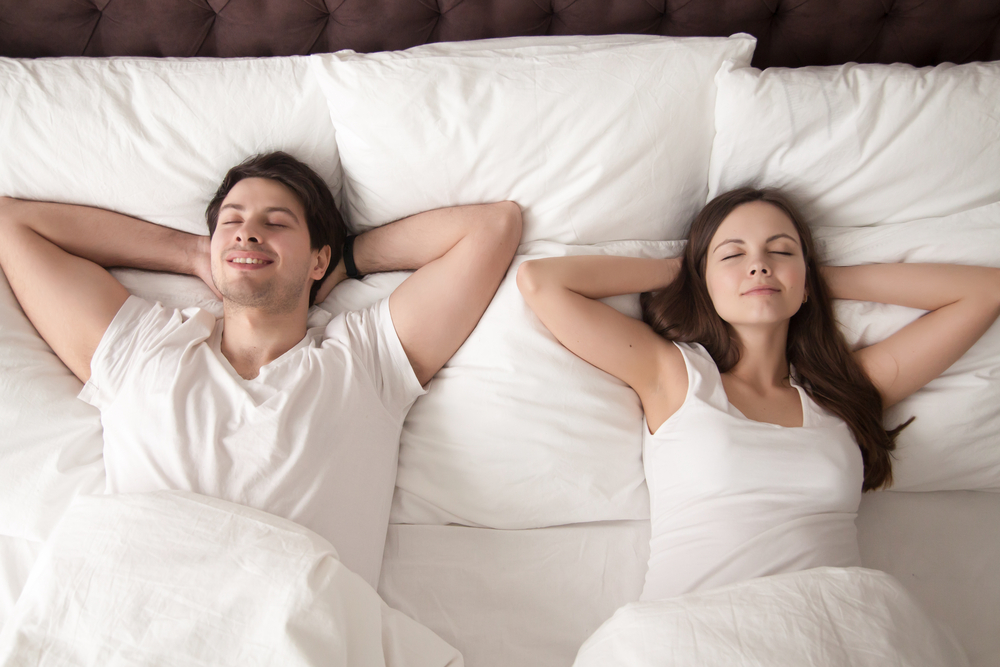 Couple sleeping in king size bed